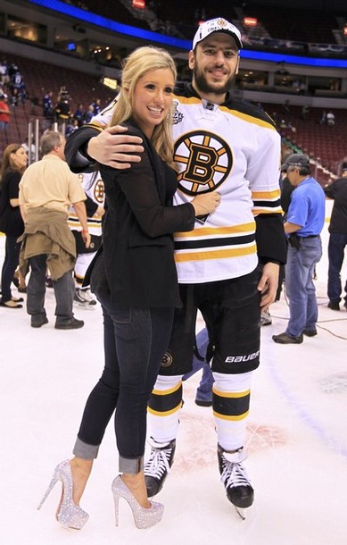 Bruins' Lucic stands on the ice with his girlfriend after his team defeated the Canucks in Game 7 of the NHL Stanley Cup Final hockey playoff in Vancouver