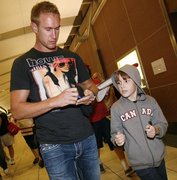 Carter of the Philadelphia Flyers signs his autograph for a young fan in Calgary