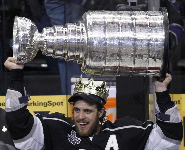 Los Angeles Kings' Anze Kopitar wears a crown as he holds up the Stanley Cup after his team defeated the New Jersey Devils in Game 6 of the NHL Stanley Cup hockey final in Los Angeles