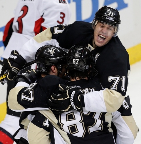 Pittsburgh Penguins' Evgeni Malkin (R) celebrates a goal by teammate Chris Kunitz (L) and Sidney Crosby against the Ottawa Senators during the first period of Game 1 of their NHL Eastern Conference semi-final hockey game in Pittsburgh, Pennsylvania May 14, 2013. REUTERS/Jason Cohn (UNITED STATES  - Tags: SPORT ICE HOCKEY)   - RTXZMR7